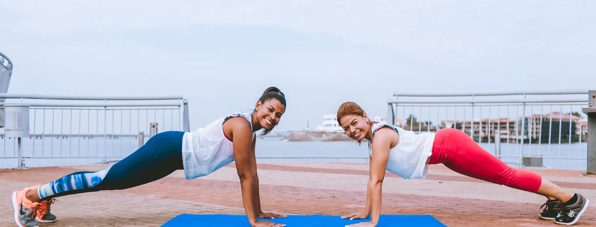 two women working out together outside