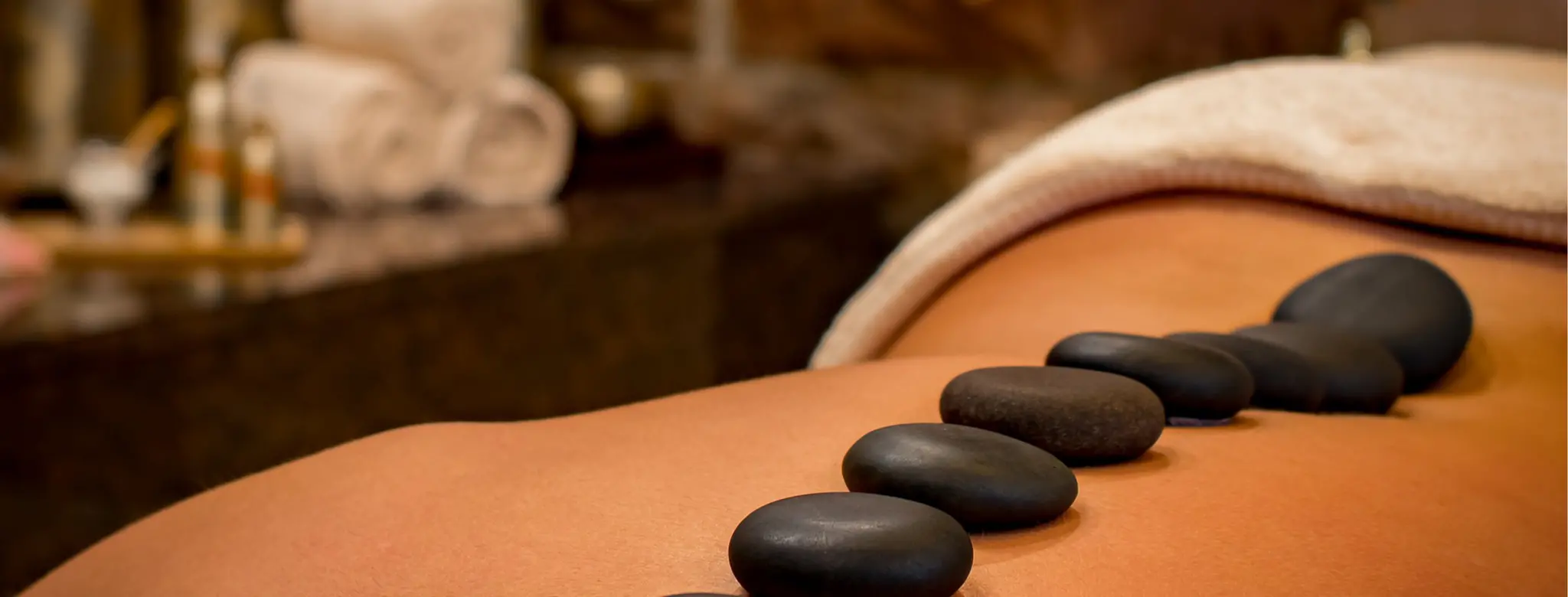 hot stones placed on persons back in spa