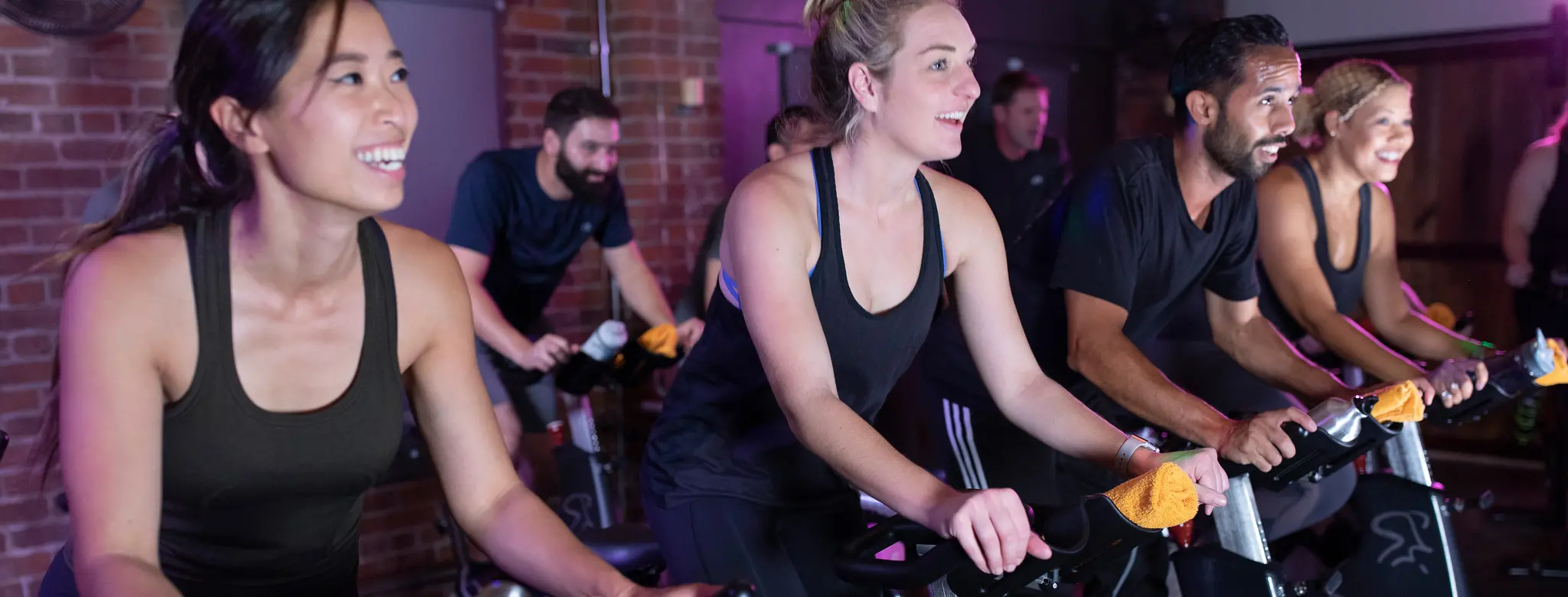 people working out in a cycling class