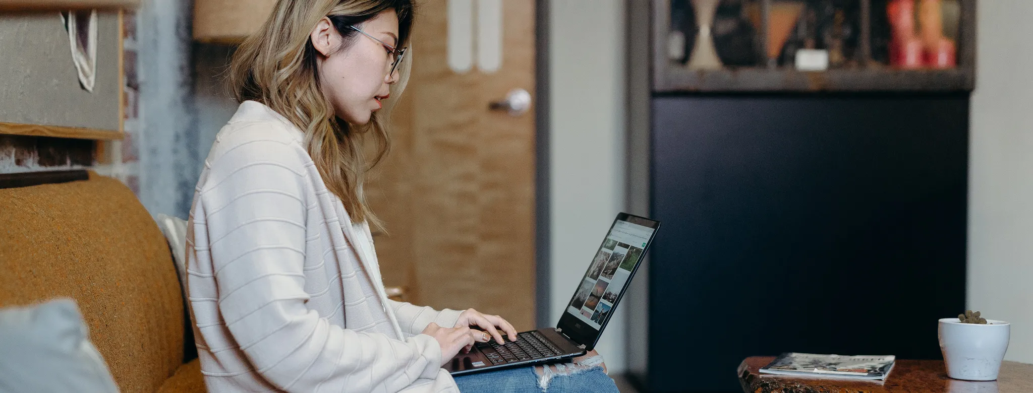 woman sitting on couch on her laptop