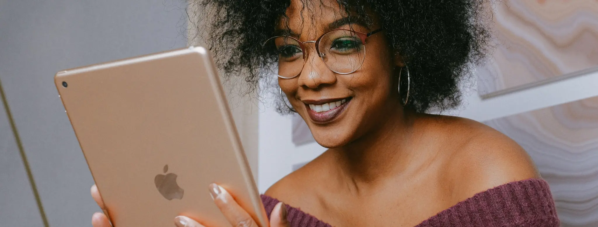 Woman smiling and working on an iPad
