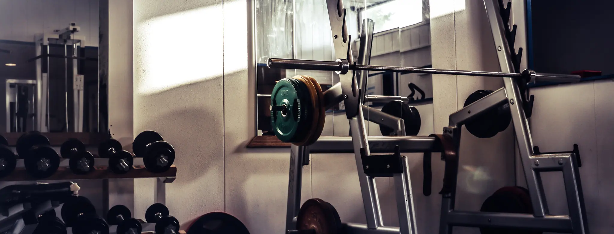 Abandoned weights in a dark, empty gym