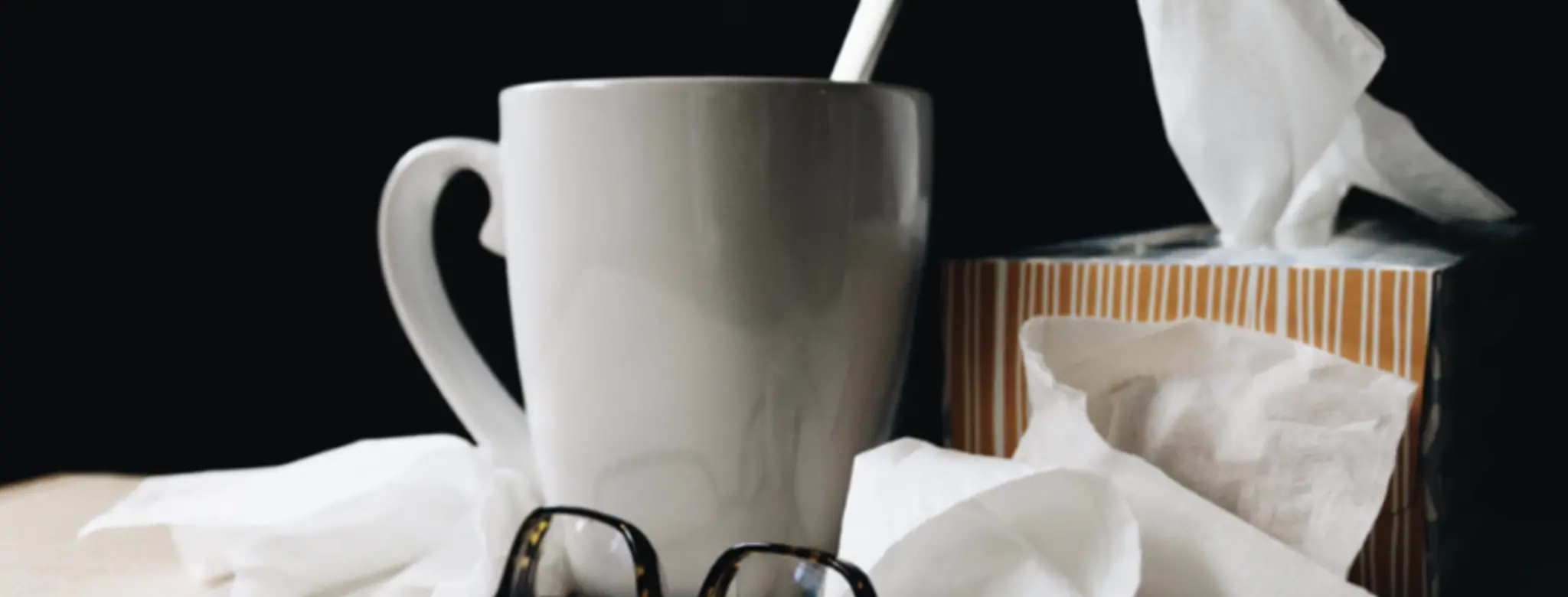 tea cup glasses and tissues on desk