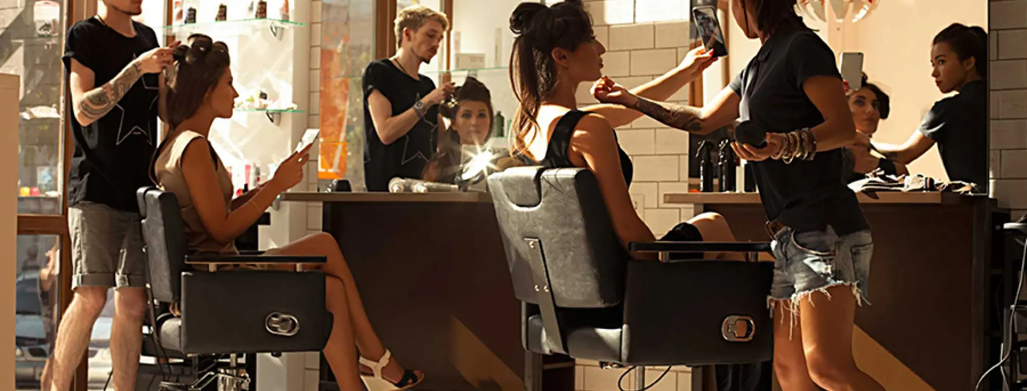 hair stylists sitting in chairs in salon