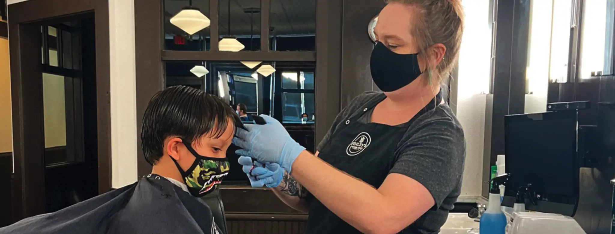 child getting hair cut in salon