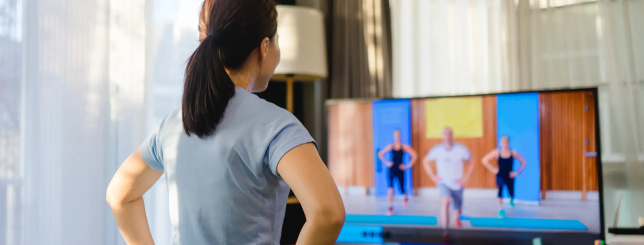 women streaming a video workout from home