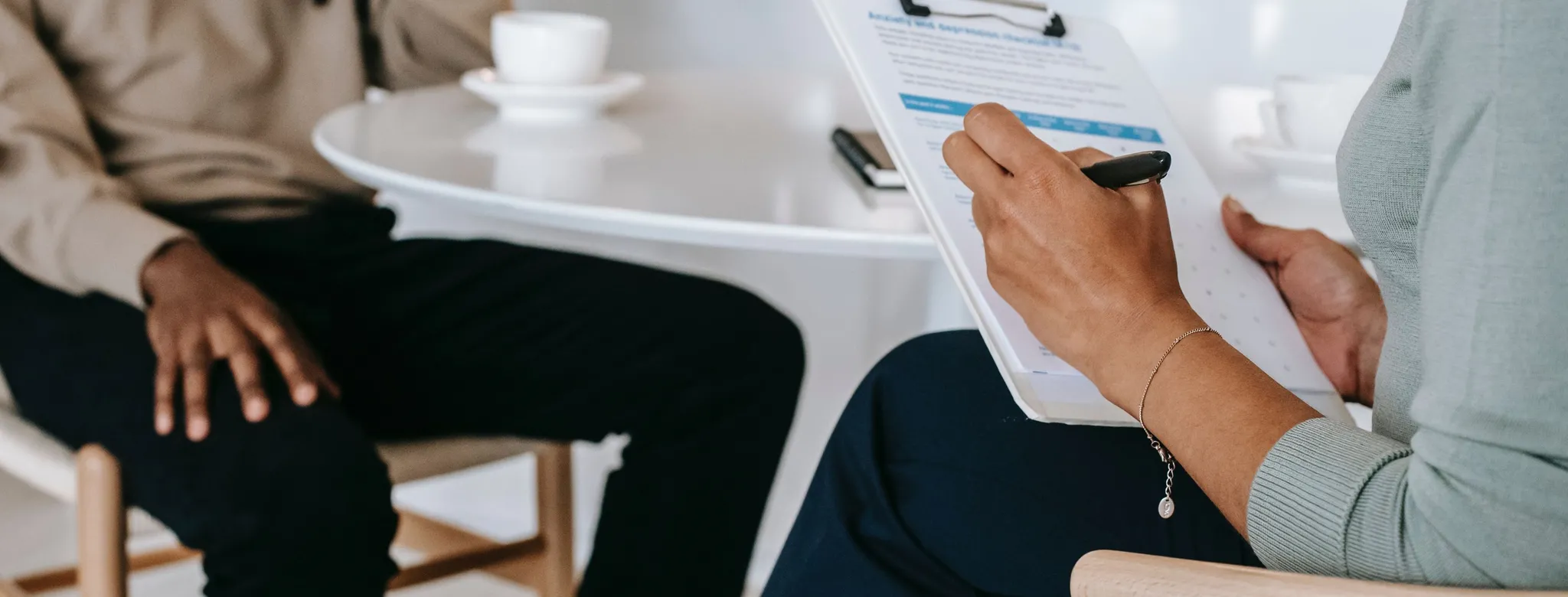 Man is interviewed for a job at a table