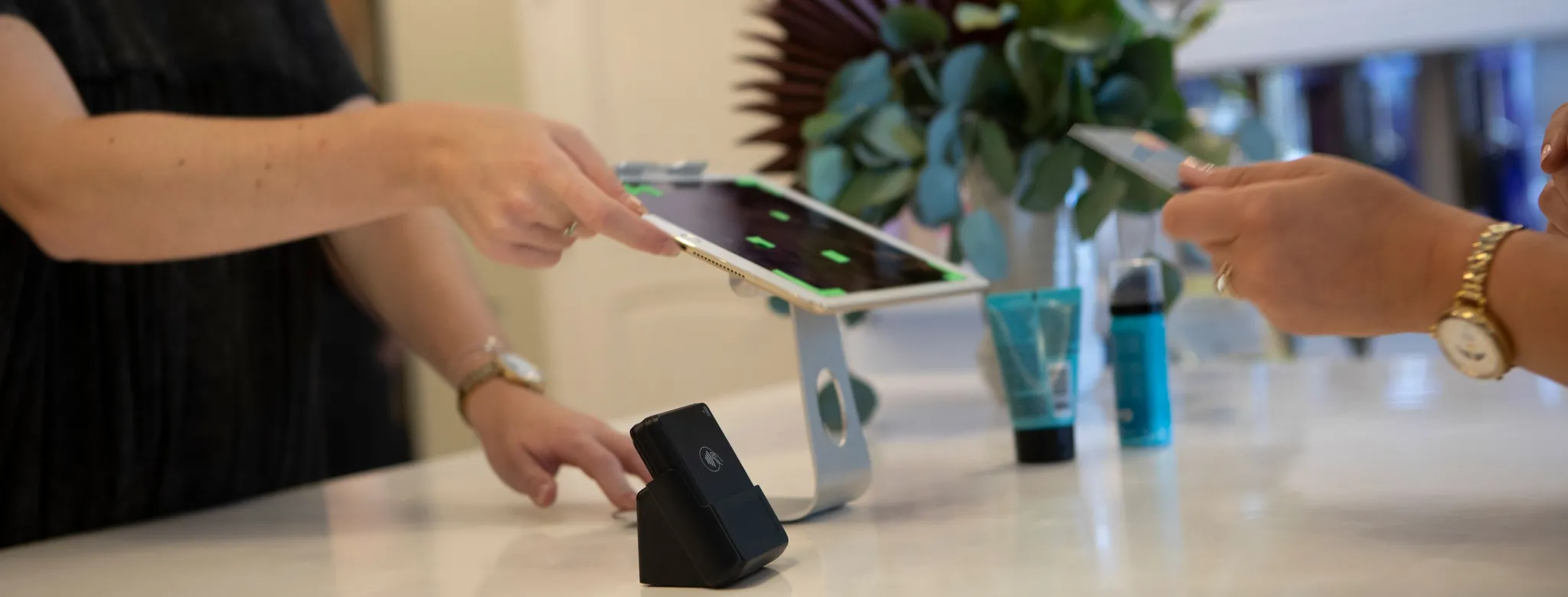 woman at desk with ipad and iphone