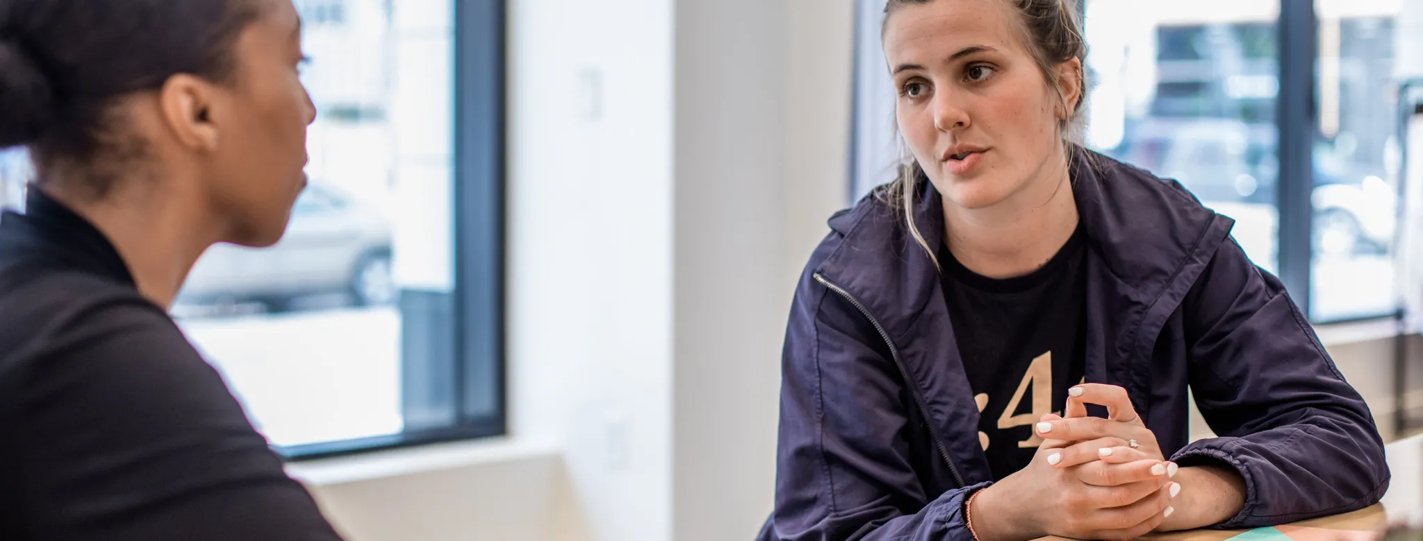 Two women discuss business