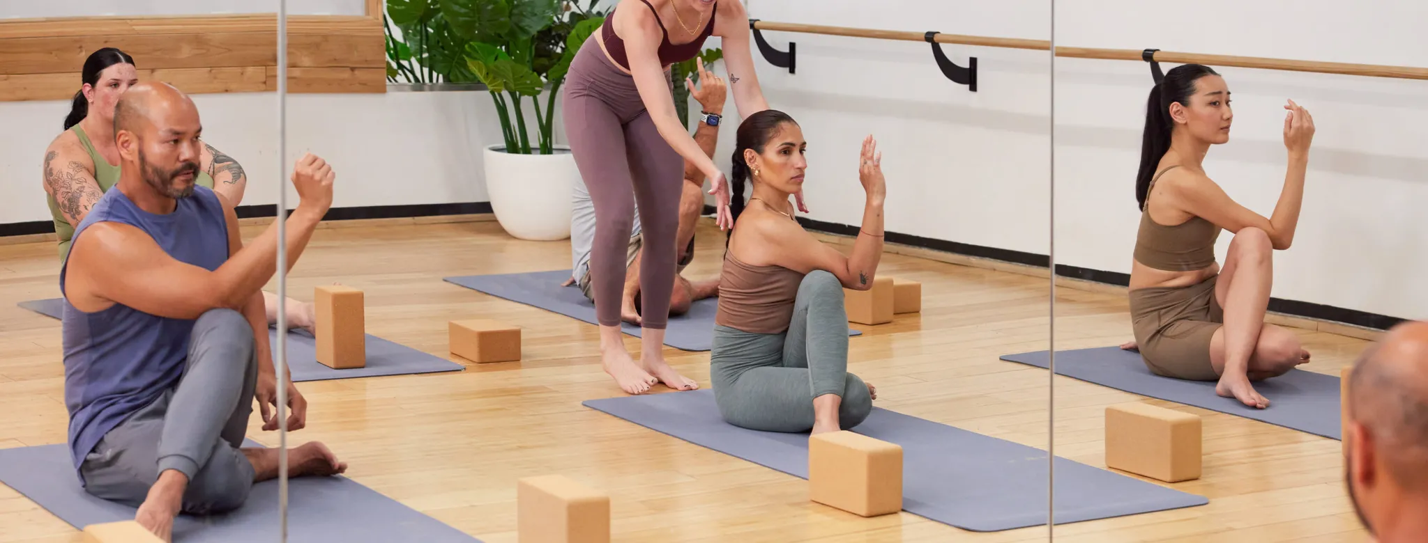 yoga teacher and students in a yoga class