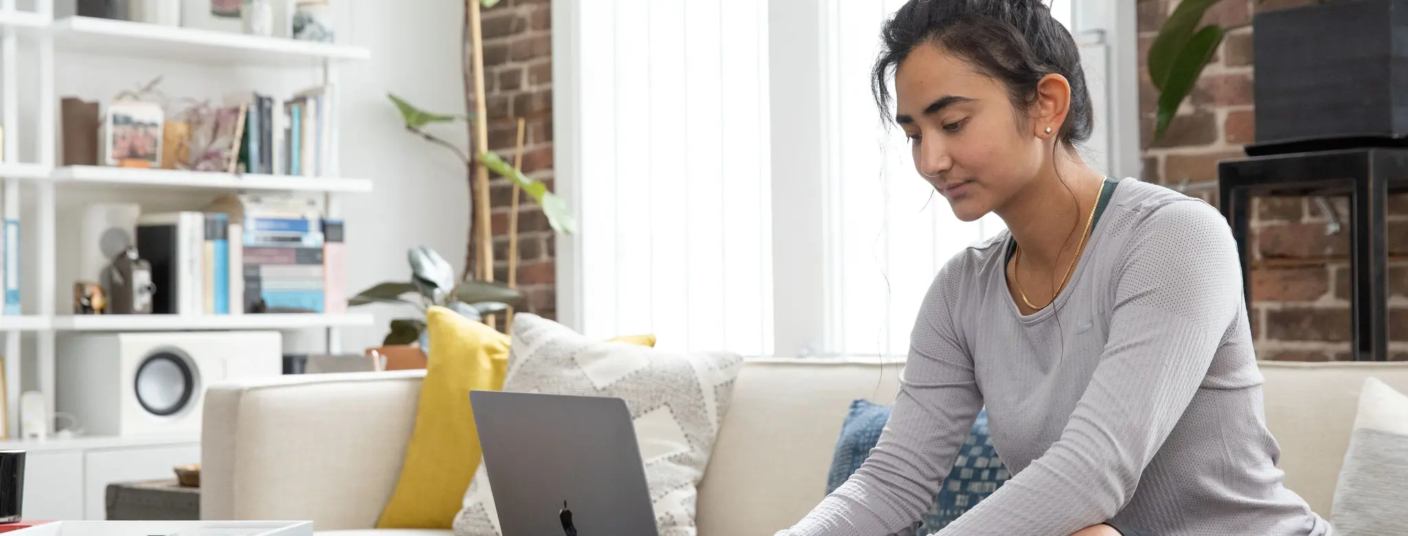 woman on couch on laptop at home