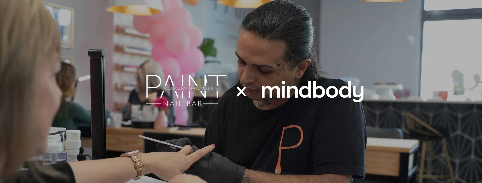 nail tech filing a woman's nails in a salon 