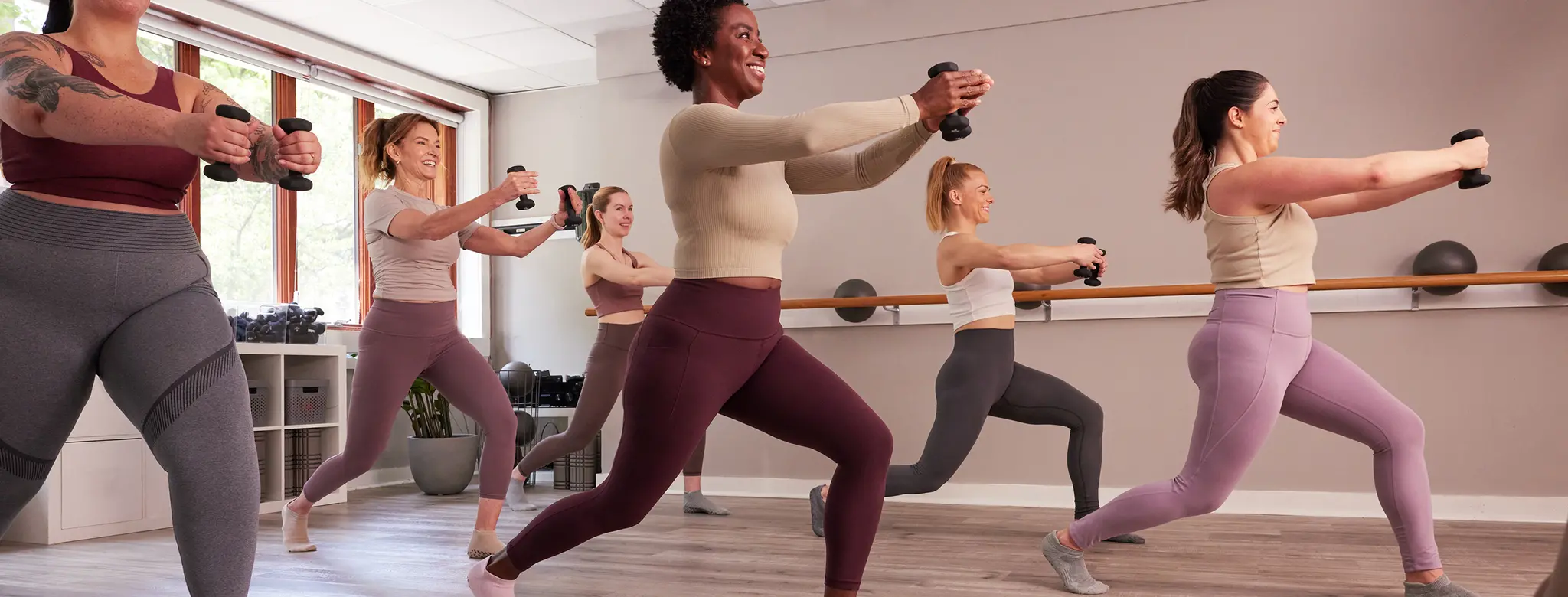 full barre class doing exercises with weights