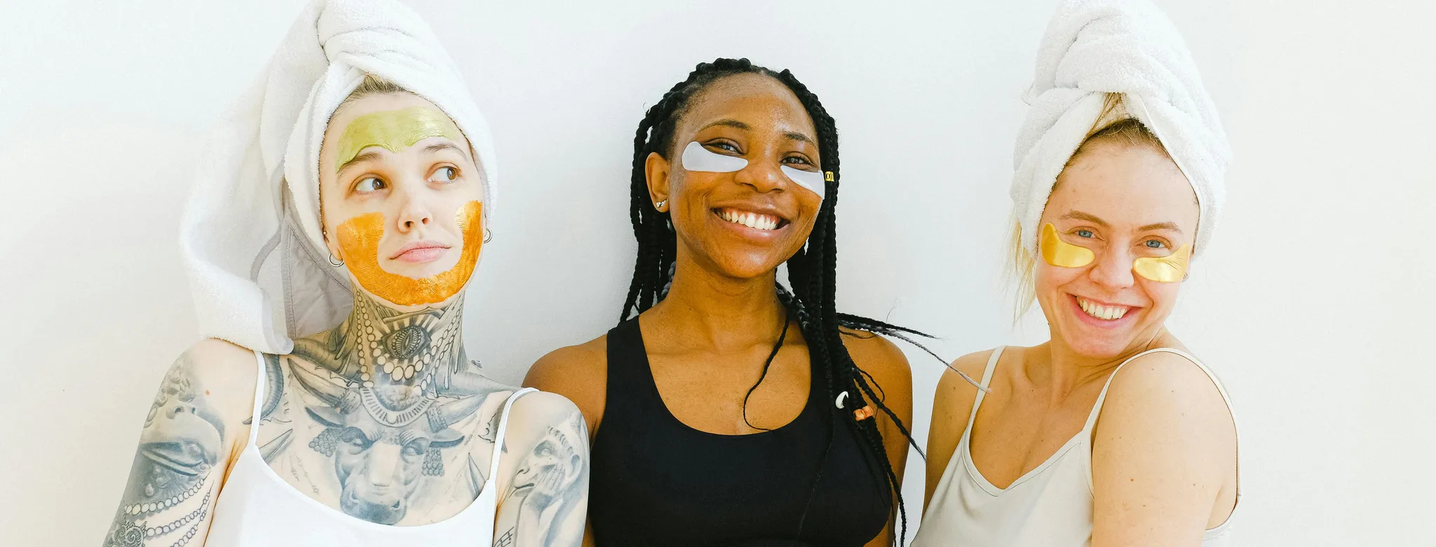 Three women smiling receiving spa treatments that they learned from WOM marketing