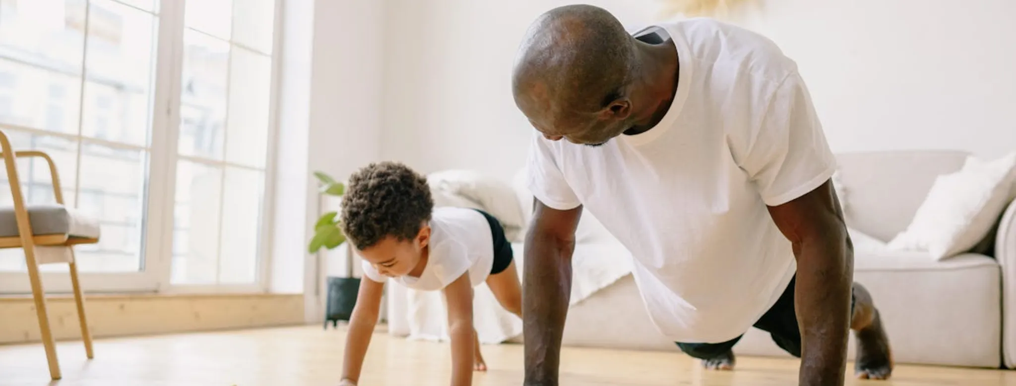 A father exercising with his son.
