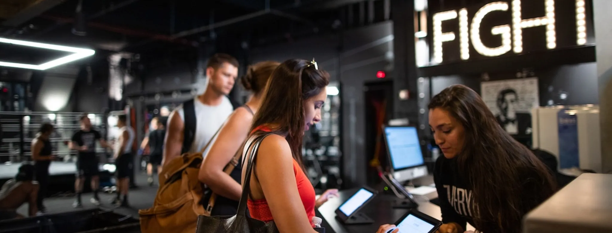 Clients checking in at the gym