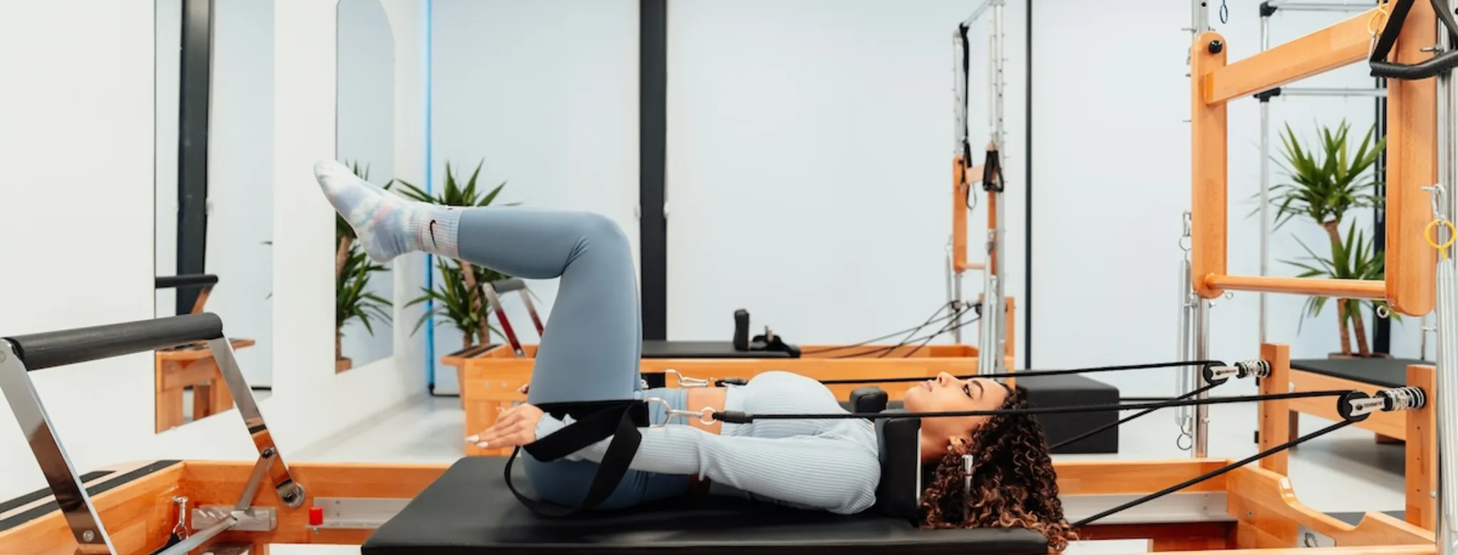 A woman doing Pilates on the reformer