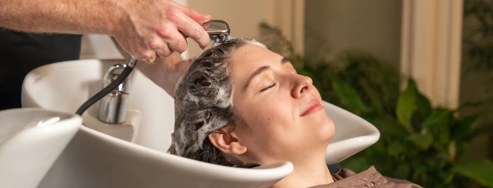 A woman getting her hair washed
