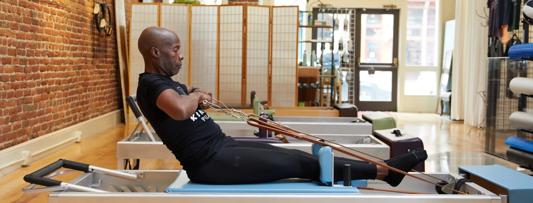 A man using a Pilates reformer