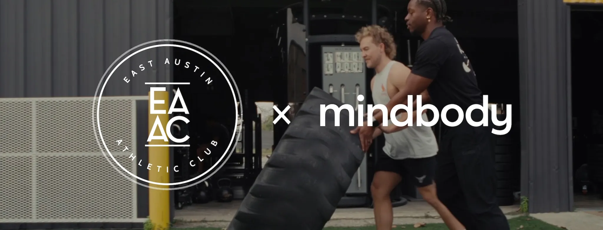 2 people working out with a tire
