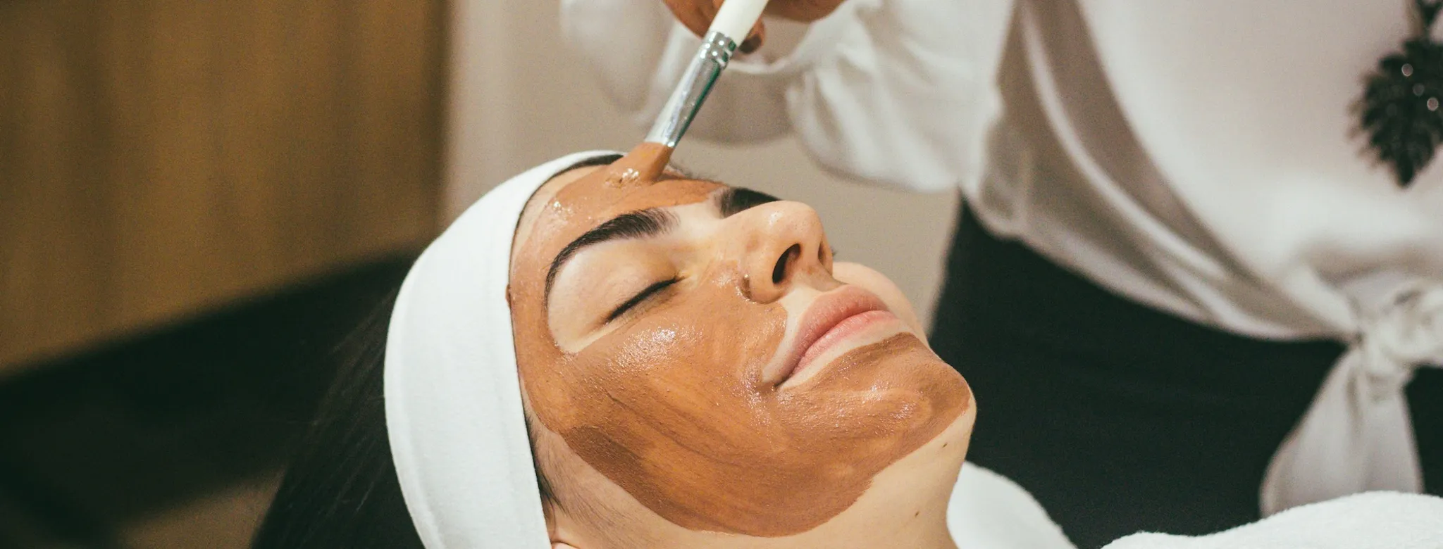 A woman getting a facial at the spa