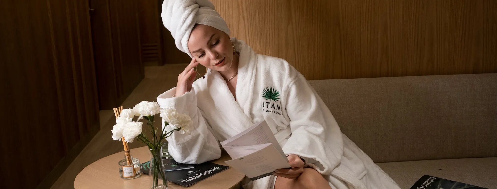 A woman sitting in a robe at the spa