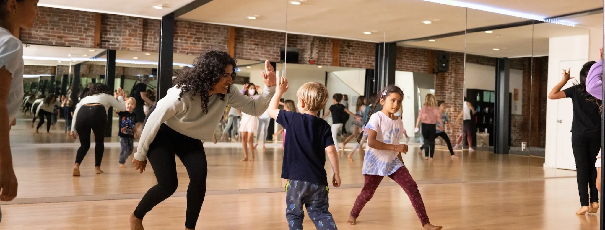 Students and an instructor in a dance class.