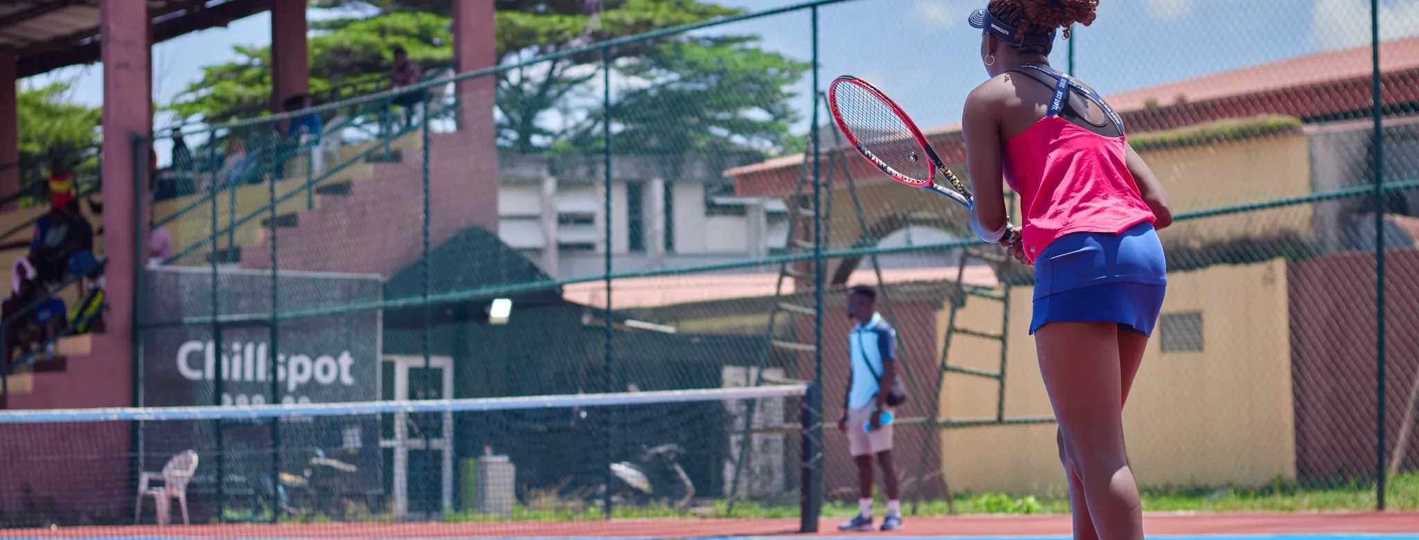 A woman on a tennis ball court