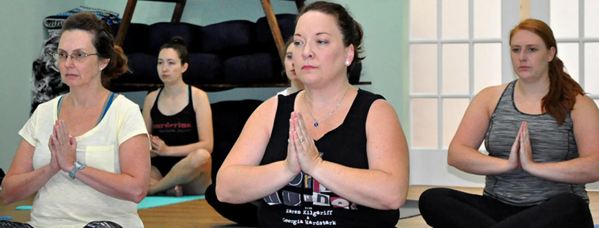 Murderinos practicing yoga at charity event for End the Backlog