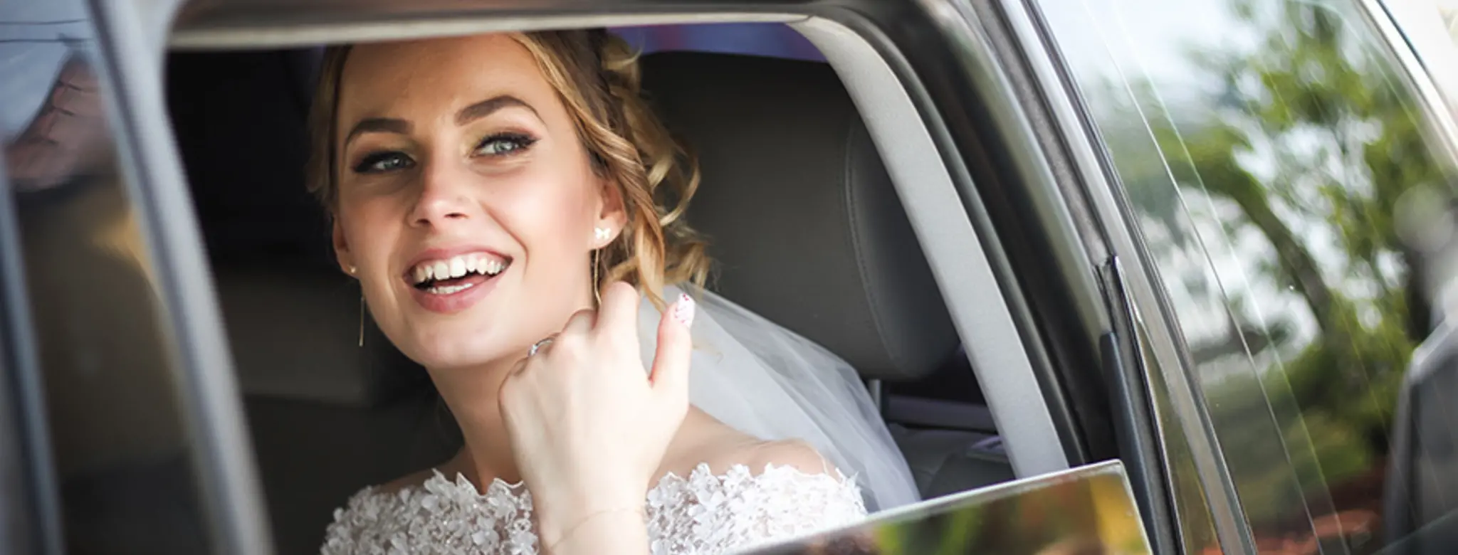 Bride smiling in car window