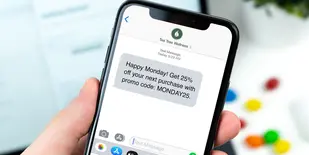 iPhone with text message with offer from wellness business