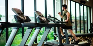 Man running on a treadmill in a health club