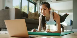 Woman doing an online workout from home