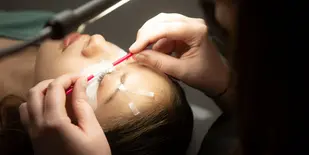woman in lash salon getting lashes done