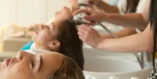 women getting hair washed at salon