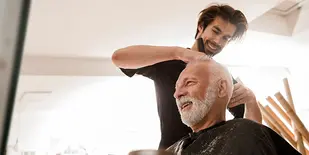 Man in barber chair getting haircut