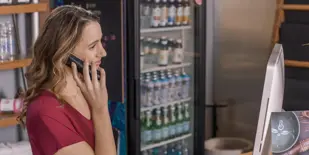 Person talking on phone at front desk