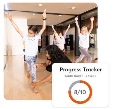 A dance instructor helps kids learn how to dance at her studio. Mindbody software helps you keep track of your students' progress.