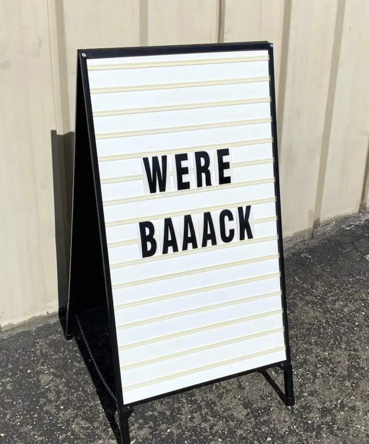 "We're back" written on a sandwich board at McAlister Training